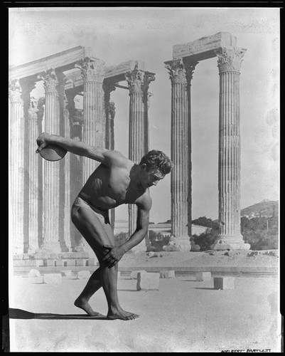 Montage photo of discus thrower, in the pose of the Greek Discobolus sculpture, superimposed on Olympieion (Temple of Zeus), 1932