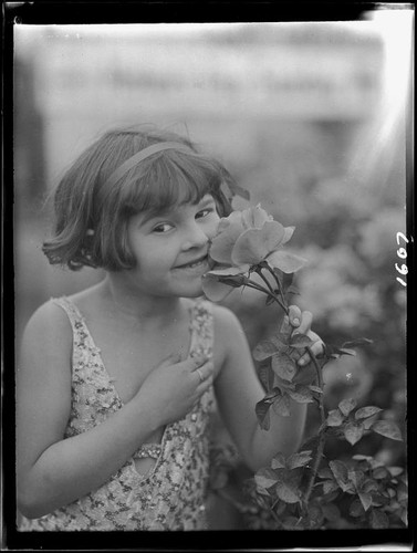 June Starr Carroll with rose, 1925