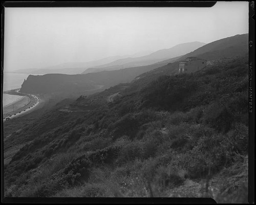 Coastal view from hill towards house under construction in the Rancho Malibu la Costa development, Malibu, circa 1927