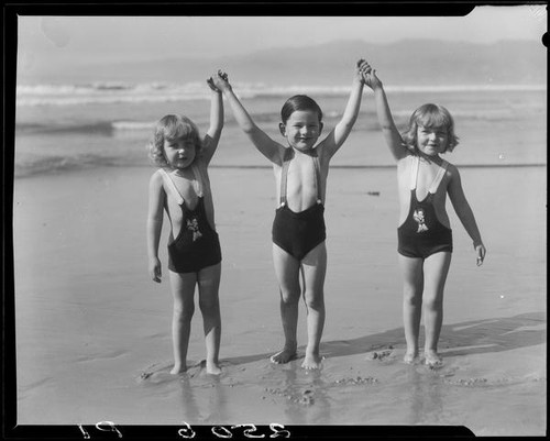 Patsy, Peggy, and Tommy Morgan posing on beach, Santa Monica, 1929