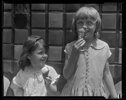 Two children eating ice cream cones from a concession at Abbot Kinney Pier, Venice, 1928