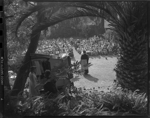 Audience watching outdoor theatrical performance, perhaps Shakespeare, [Santa Monica?], 1956-1957