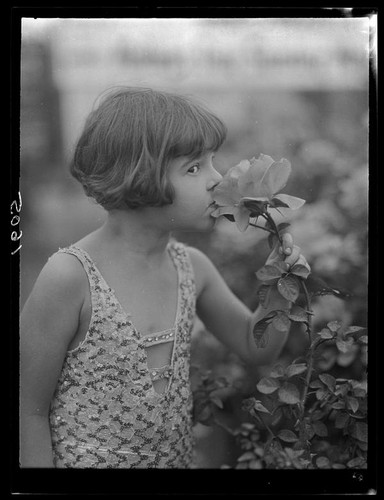 June Starr Carroll with rose, 1925