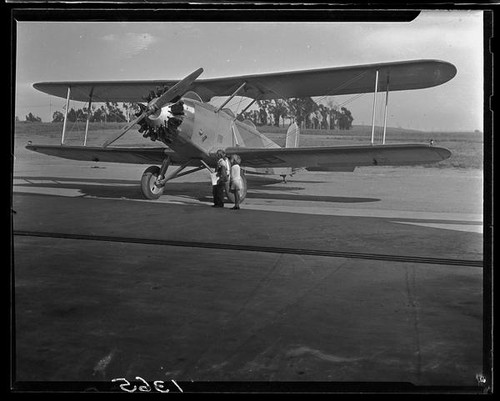 Biplane and children at airfield, [1920s?]