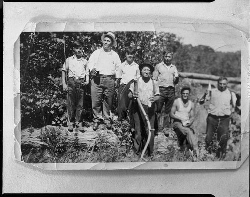 Men and boys with log and scythe, [1920s?, rephotographed 1940s?]