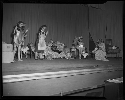 Lucille S. King, ventriloquist, on stage with three child actresses, 1951