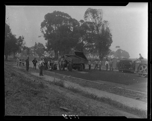 Asphalt trucks and workers on road under construction in Huntington Palisades, Pacific Palisades, 1929