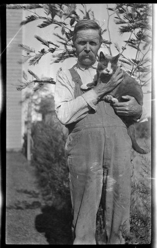 Harve Brillhart, uncle of Adelbert Bartlett, holding his cat, "Puss," near Patterson, 1927