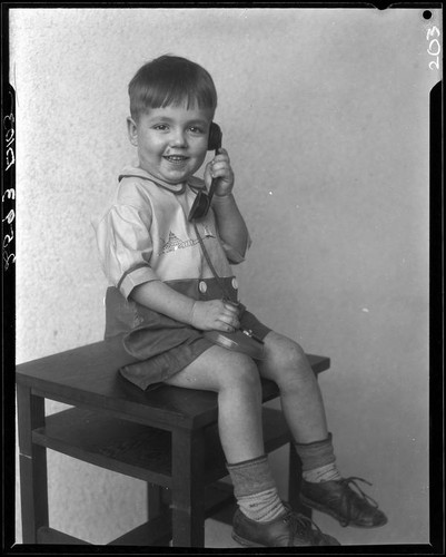 Boy with toy telephone, Los Angeles, circa 1935