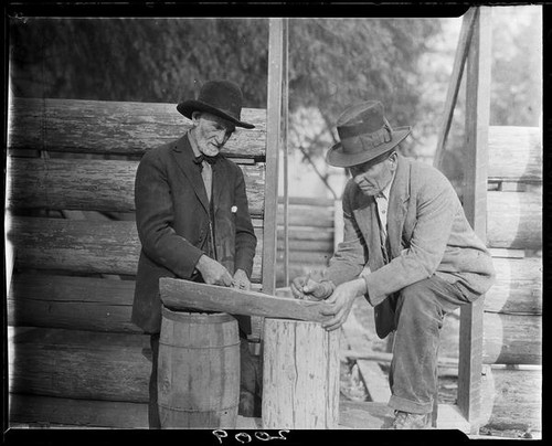 Men building log cabin, San Bernardino, 1925-1928