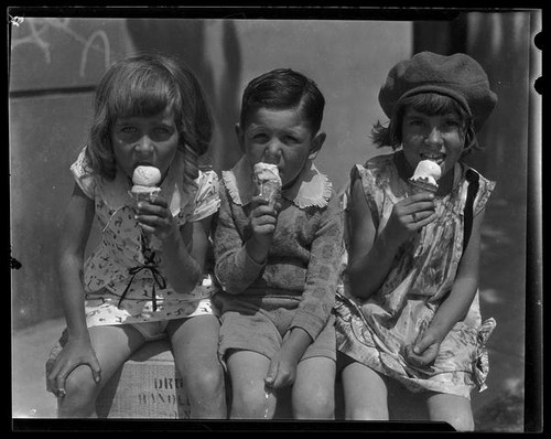 Three children eating ice cream cones from a concession at Abbot Kinney Pier, Venice, 1928