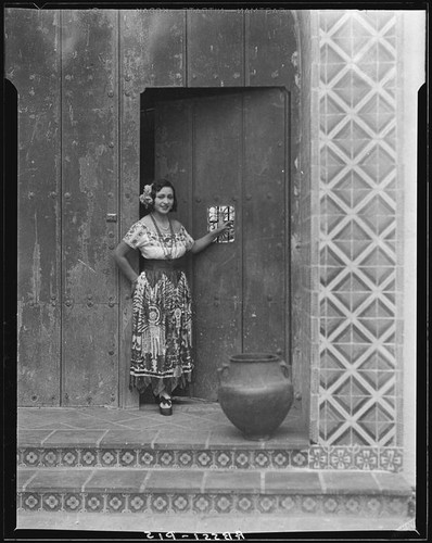 Woman in traditional Mexican dress in front of Hotel Playa de Ensenada, Ensenada, 1931