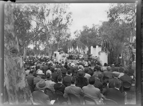 Outdoor event with flags and military veterans, [Los Angeles?], [1949?]