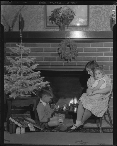 Children at fireplace with Christmas decorations, Los Angeles, circa 1935