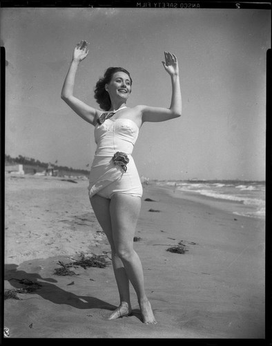 Betty Herrick [?] on beach, [1935-1955]