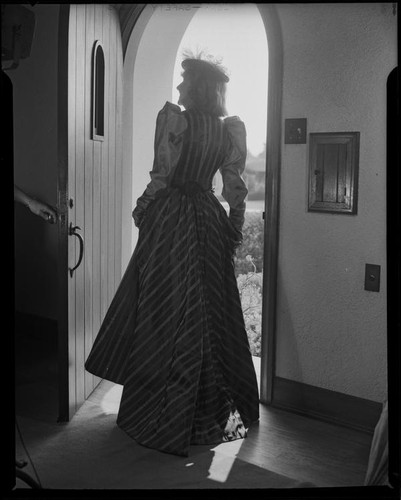 Lucille S. King, actress and ventriloquist, in the doorway of the Bartlett residence, 1951