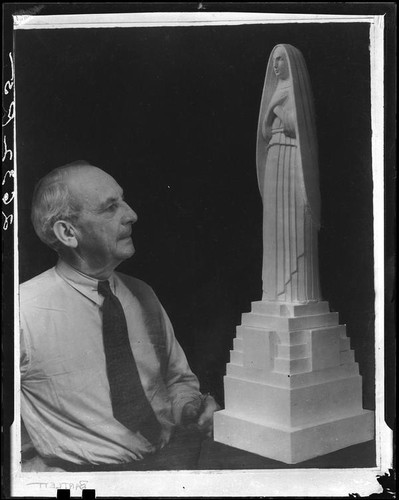 Sculptor Eugene Morahan with a model of his statue of Saint Monica, circa 1934