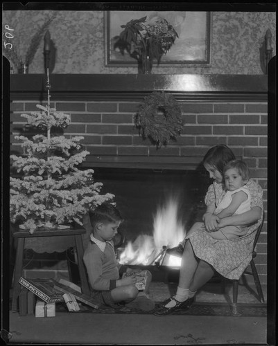 Children at fireplace with Christmas decorations, Los Angeles, circa 1935