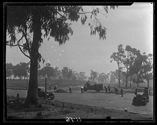 Workers spreading asphalt on road under construction in Huntington Palisades, Pacific Palisades, 1929