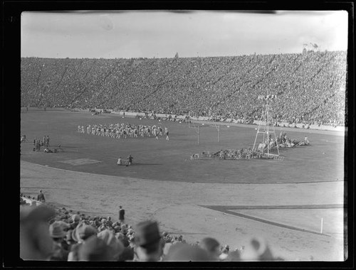 Marching band in crowded stadium, [Pasadena?], [1920s?]