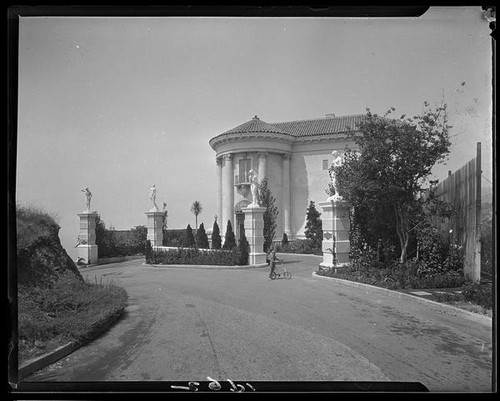 Villa de Leon (Leon Kauffmann residence) with boy standing in front, Pacific Palisades, 1929