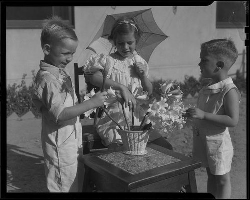 Children arranging Easter lilies, Los Angelse, circa 1935