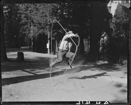 Rodeo performer Tex Young doing rope trick, Lake Arrowhead Rodeo, Lake Arrowhead, 1929