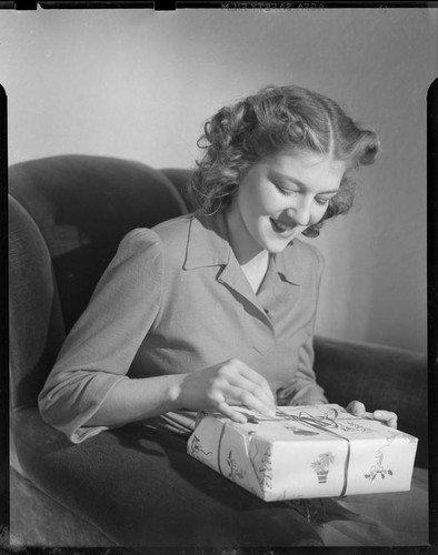 Betty Hanna holding gift, 1941