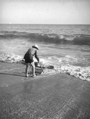 Sifting sand at Balboa Beach