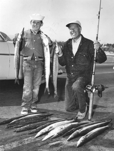 Wild Bill Elliot and son pose with barracuda they caught