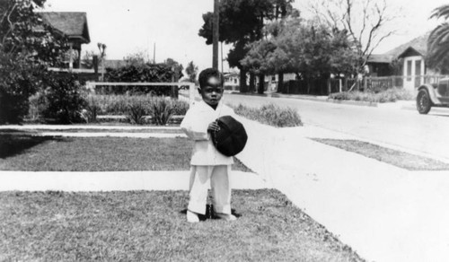 Boy in suit in front yard