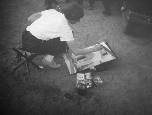 Woman painting the San Fernando Mission