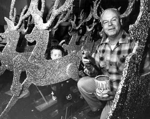 Santa Herb Smith and his son, Bobbie, 4, in the workshop