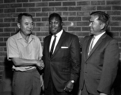 Boxer Jimmy Carter and unidentified men