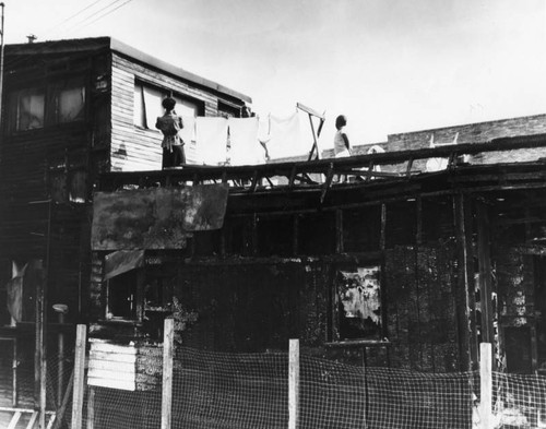 Woman hanging laundry, slum dwelling