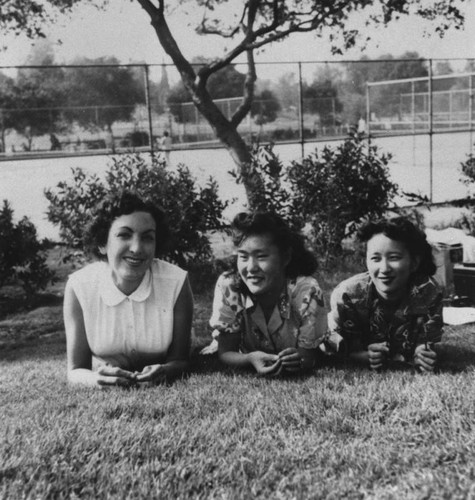 Three women relaxing on the grass