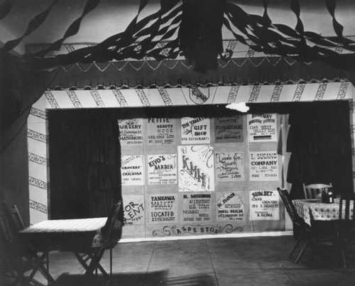 Kensington Music Hall set with sponsors' ads on curtain