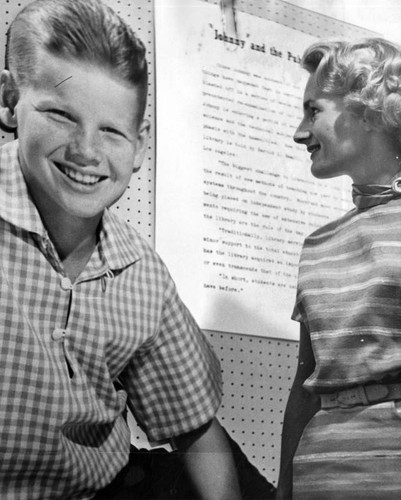 Receptionist checks library progress