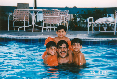 Father swimming with sons