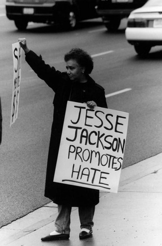 Woman carrying a protest sign