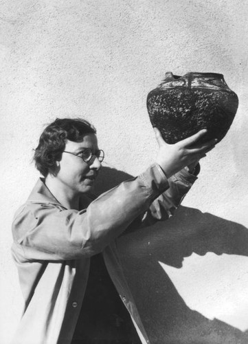 Holding a Native American ceramic pot