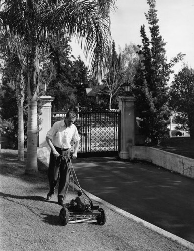 Ralph Bellamy mowing lawn