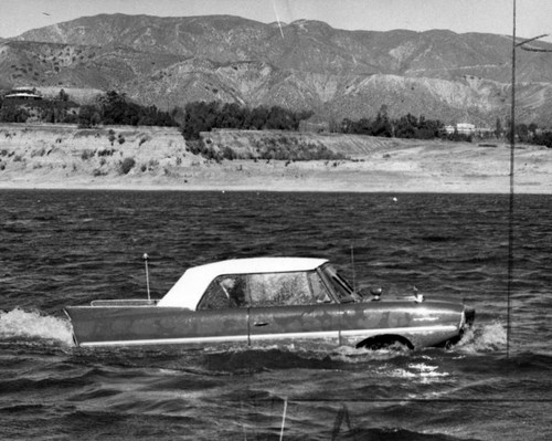 Snub-nosed 'Amphicar' rides choppy waves of Hansen Lake in Pacoima