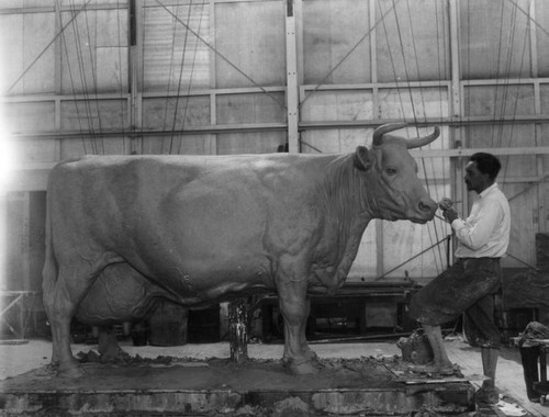 Sculptor with his cow