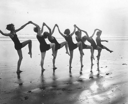 Women dancing on beach, Long Beach