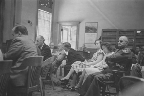 Courtroom scene, Bud confers with attorney