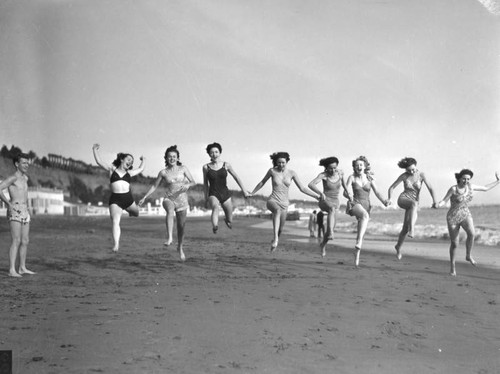 Group of acrobats on the beach, view 4