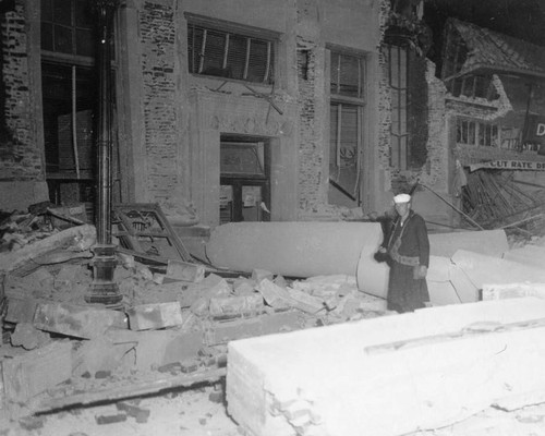 Sailor at earthquake-damaged building