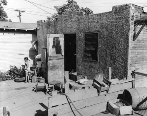 Child playing outside a slum dwelling