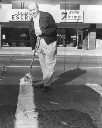 Dentist Louis J. Friedman painting crosswalk across Ventura Blvd